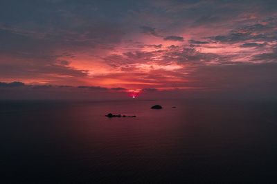 Scenic view of sea against romantic sky at sunset