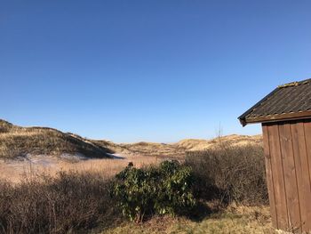 Scenic view of land against clear blue sky