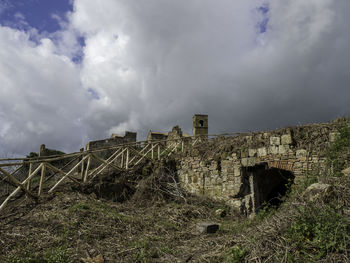 Old building against cloudy sky