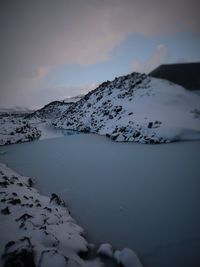 Scenic view of lake against sky during winter