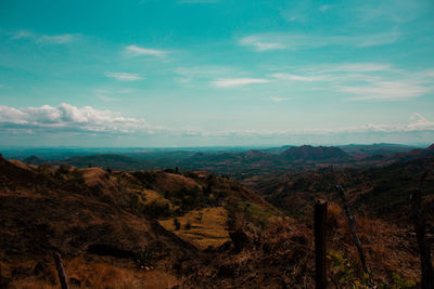 Scenic view of mountains against blue sky