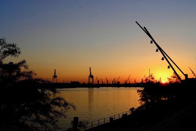 Scenic view of silhouette trees against orange sky