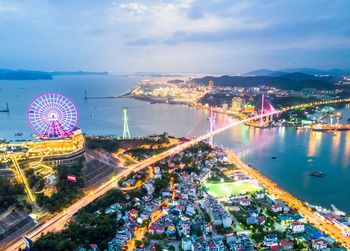 High angle view of illuminated ferris wheel in city