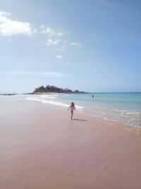 Woman on beach against sky