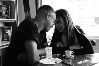 Young couple sitting on table