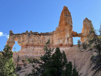 Rock formations on mountain against clear blue sky