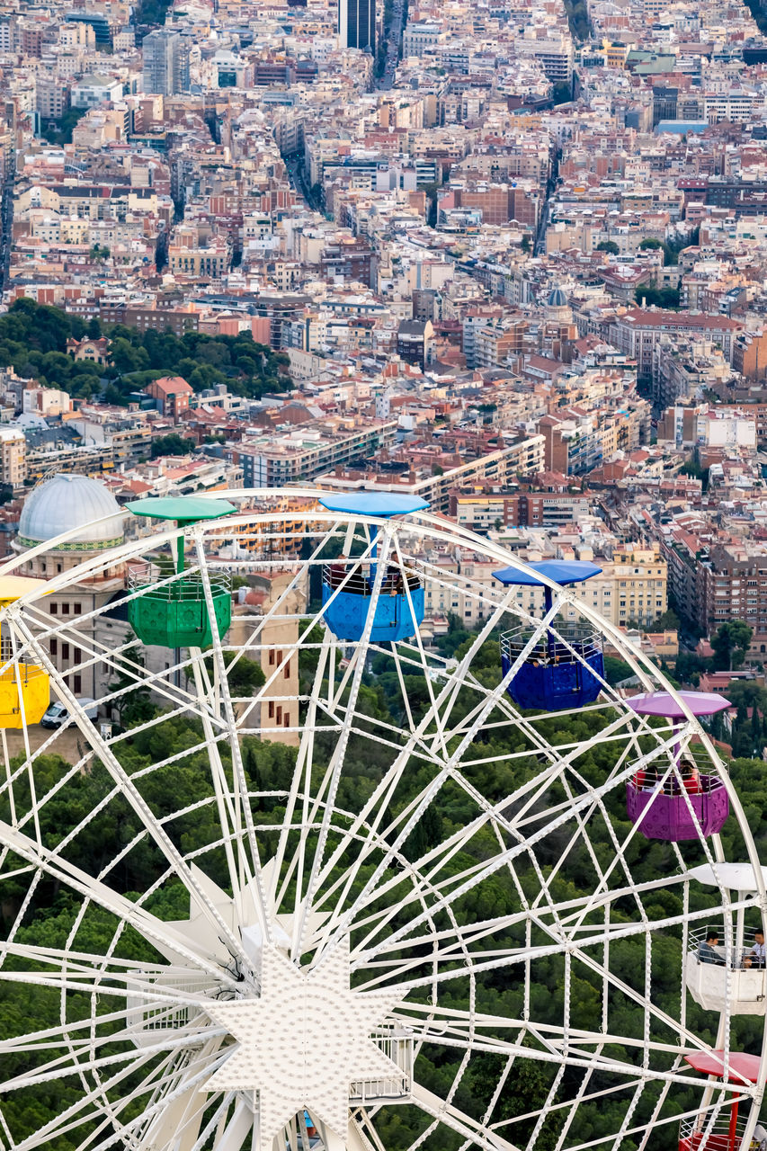 HIGH ANGLE VIEW OF FERRIS WHEEL AGAINST BUILDINGS