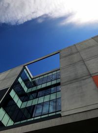 Low angle view of modern building against blue sky