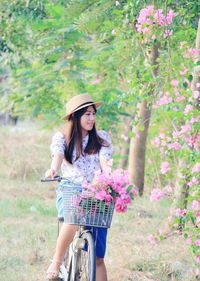 Young woman riding bicycle at park