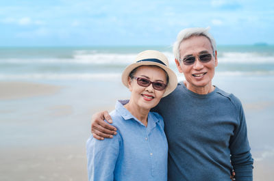 Portrait of a smiling young couple on beach