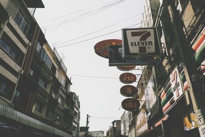 Low angle view of road sign against sky