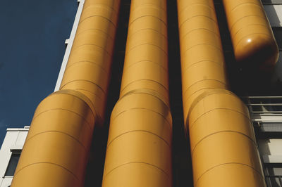 Low angle view of pipes against sky