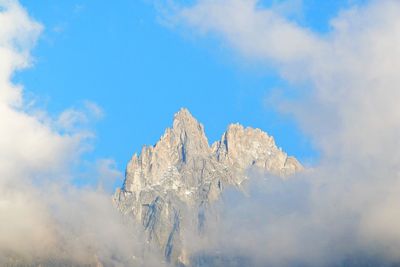 Low angle view of snow on mountain against sky