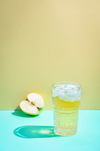 Close-up of juice and apple in studio