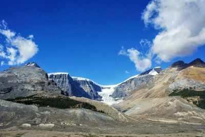 Low angle view of mountains against blue sky