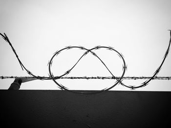 Barbed wire against clear sky