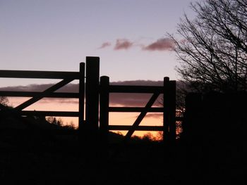 Silhouette built structure against sky at sunset