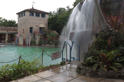 Scenic view of waterfall against trees