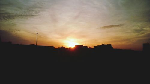 Silhouette of built structure at sunset