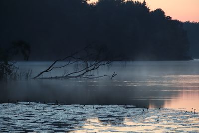 Scenic view of lake against sky during winter