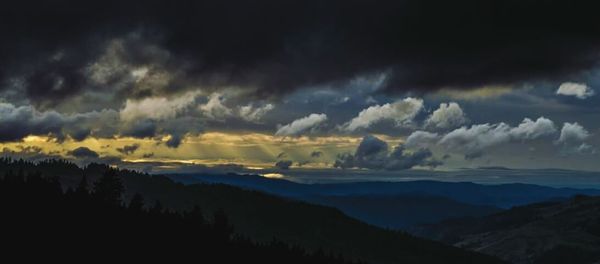 Scenic view of mountains against cloudy sky