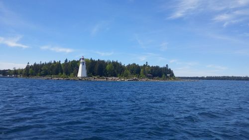 Scenic view of sea by building against sky