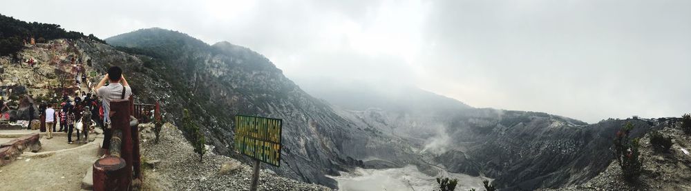 Scenic view of mountains against cloudy sky