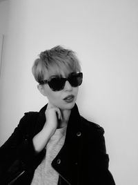 Portrait of boy wearing sunglasses against white background