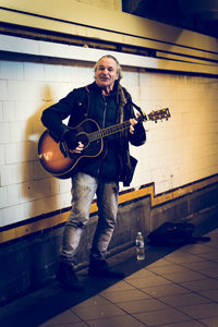 Portrait of man holding guitar