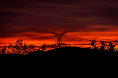 Silhouette of bare tree against dramatic sky