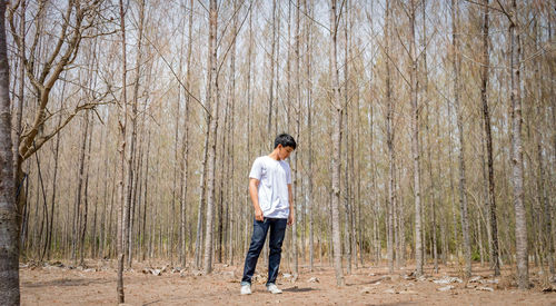 Full length of man standing in forest