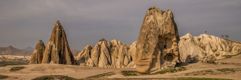 Panoramic view of arid and rocky landscape against sky in cappadocia