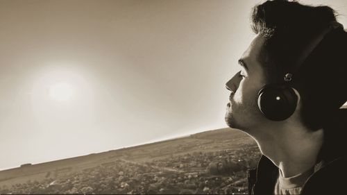 Man photographing camera against sky