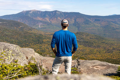 Rear view of man standing on rock