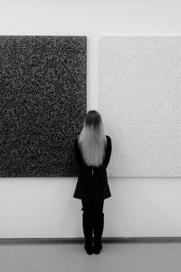 Rear view of woman standing on floor