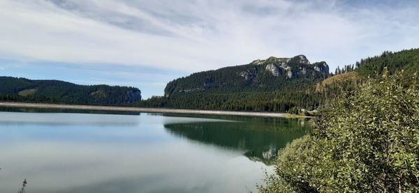 Scenic view of lake and mountains against sky