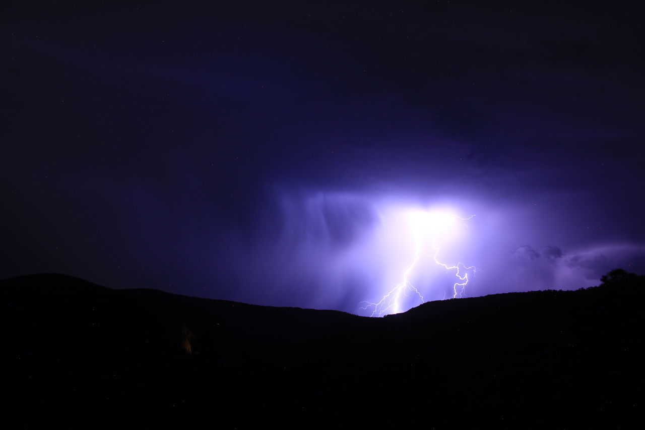 lightning, power in nature, night, storm, beauty in nature, thunderstorm, cloud, sky, thunder, mountain, environment, warning sign, scenics - nature, dramatic sky, darkness, silhouette, nature, sign, no people, communication, storm cloud, forked lightning, dark, illuminated, outdoors, landscape, light - natural phenomenon