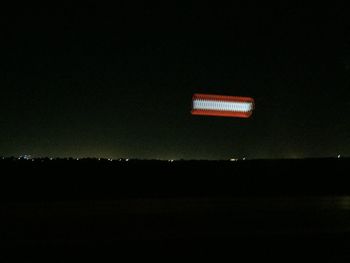 Silhouette landscape against sky at night