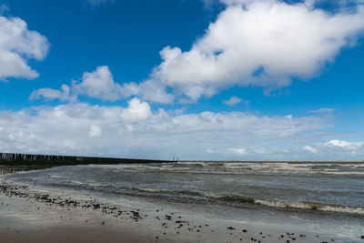 Scenic view of beach against blue sky