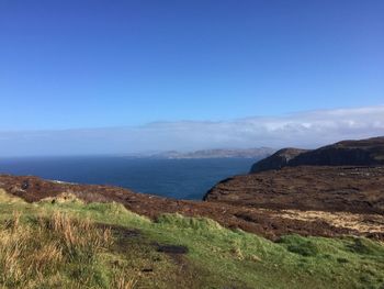 Scenic view of sea against clear blue sky