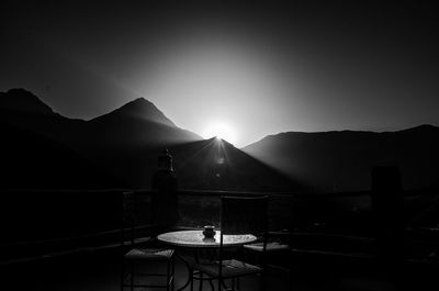 Silhouette people on mountain against clear sky