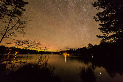 Scenic view of lake against sky at night