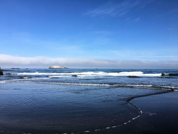 Scenic view of sea against blue sky