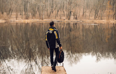 Full length rear view of man on lake