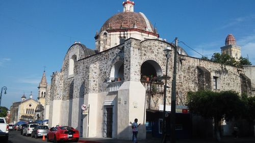 Man standing against building in city