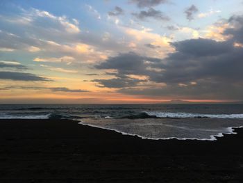 View of calm beach at sunset