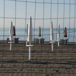 Chairs on beach against sky