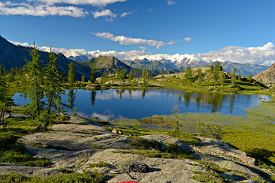 Scenic view of lake and mountains against sky