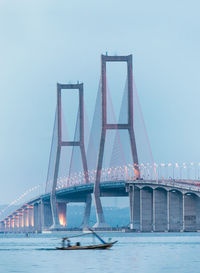View of bridge over river in city