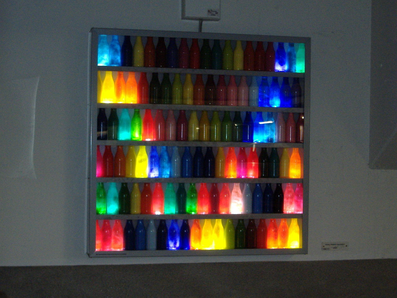 CLOSE-UP OF COLORFUL WINDOW IN ILLUMINATED ROOM